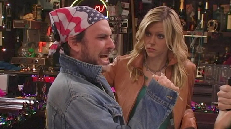 Charlie Day as Charlie singing in front of Kaitlyn Olsen as Dee in It's Always Sunny in Philadelphia.