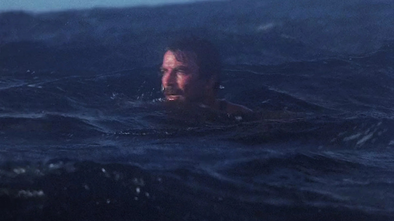 Tom Selleck as Thomas Magnum, poking his head above water in Magnum, P.I.