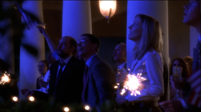 White House staffers hold sparklers and flags in The West Wing.