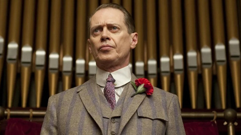 Steve Buscemi's Nucky Thompson standing in front of a church organ on Boardwalk Empire