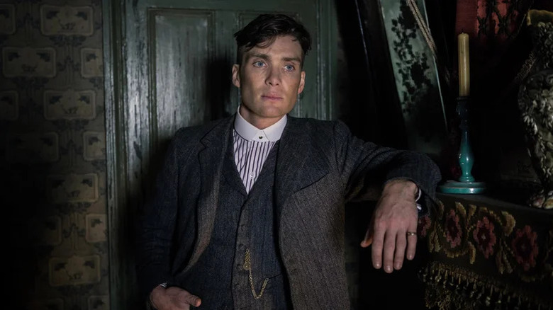 Cillian Murphy's Tommy Shelby leaning on a mantelpiece on Peaky Blinders