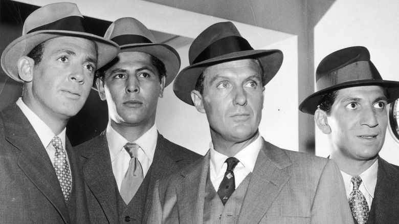 Jerry Paris' Martin Flaherty, Abel Fernandez's William Youngfellow, Robert Stack's Eliot Ness, and Nicholas Georgiade's Rico Rossi standing together on The Untouchables
