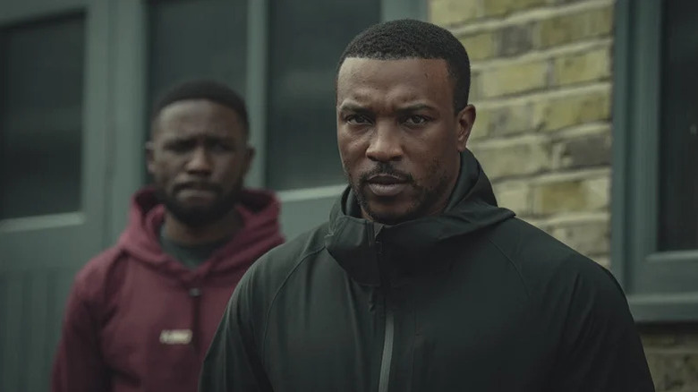 Ashley Walters' Dushane Hill wearing a windbreaker outdoors on Top Boy