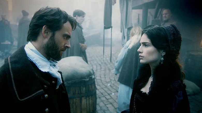 Samuel Wainwright (Stuart Townsend) stares intently at Mary Sibley (Janet Montgomery) in a busy street in Salem