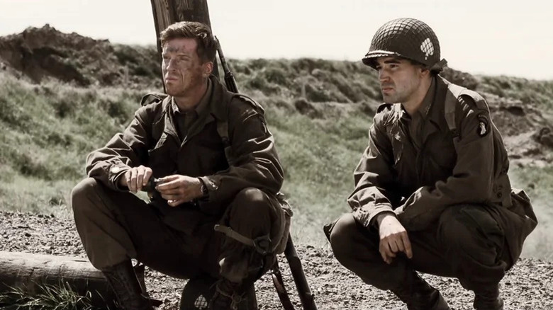 Dick Winters (Damian Lewis) and Lewis Nixon (Ron Livingston) crouch together on a battlefield in Band of Brothers