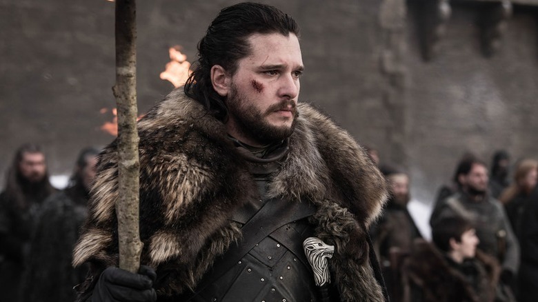 Jon Snow (Kit Harington) grimly holds a torch on Game of Thrones