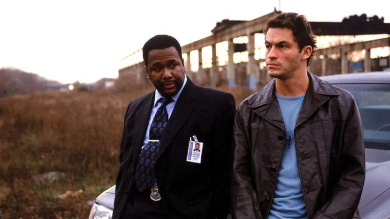Bunk Moreland (Wendell Pierce) and Jimmy McNulty (Dominic West) recline against a car overlooking the horizon on The Wire