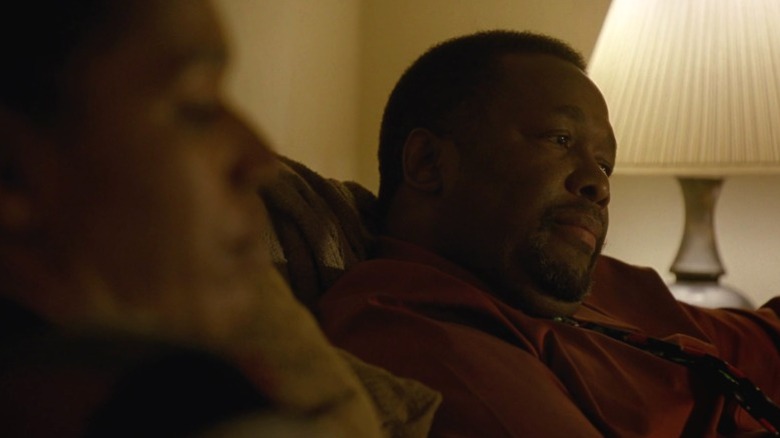 Antoine sitting in the couch next to Desiree on Treme S3E5