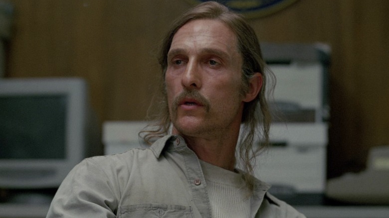 Rust sitting in the interview room on True Detective S1E4