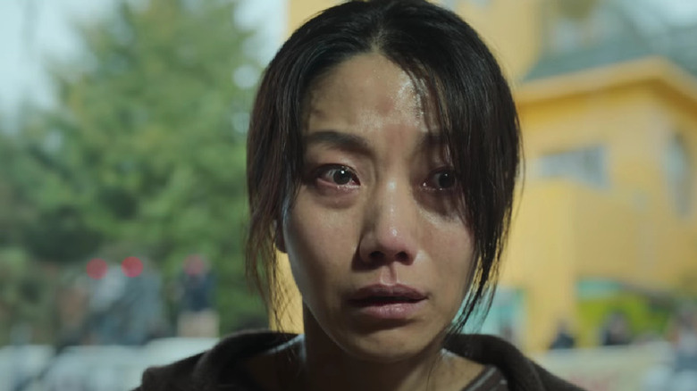 Park Jeong-ja (Kim Shin-rok) tearfully awaits her fate in Hellbound