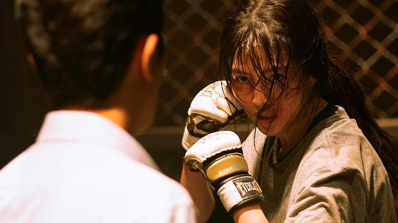 Yoon Ji-woo (Han So-hee) stands with her fists raised in a cage match in My Name