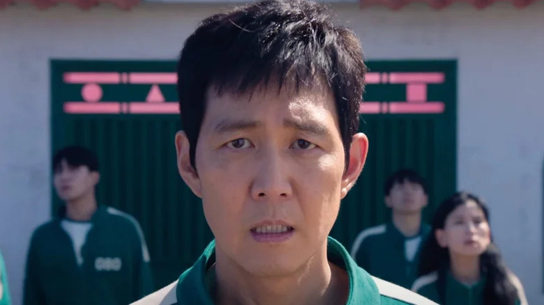Seong Gi-hun (Lee Jung-jae) stares frustratedly ahead in Squid Game