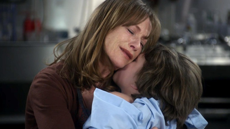 Dr. Sophie Gerard (Isabelle Huppert) holds her son Nicholas (Jake Miller) in Law and Order Special Victims Unit.