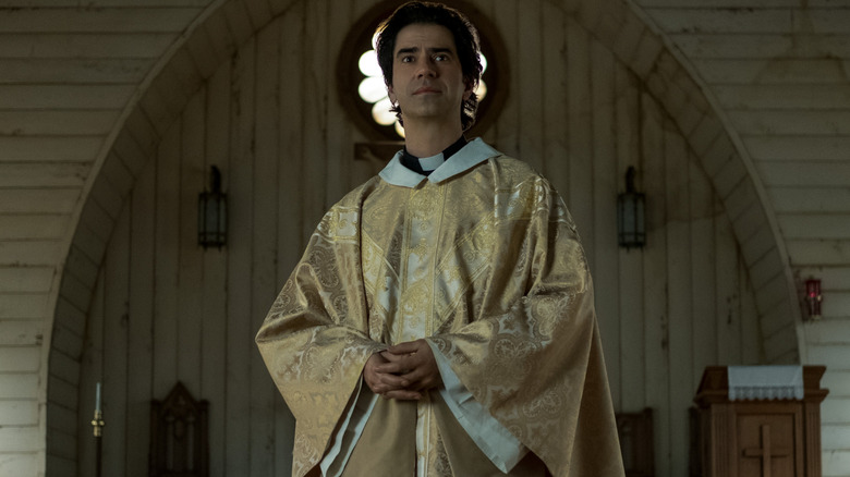 Father Paul (Hamish Linklater) presiding over mass on Midnight Mass