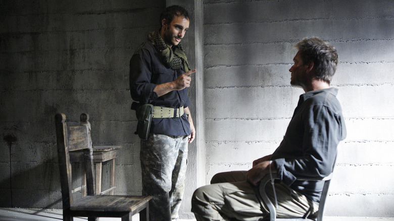 Michael Weatherly's Tony DiNozzo looking determined while Omid Abtahi's Saleem Ulman looms over him on NCIS