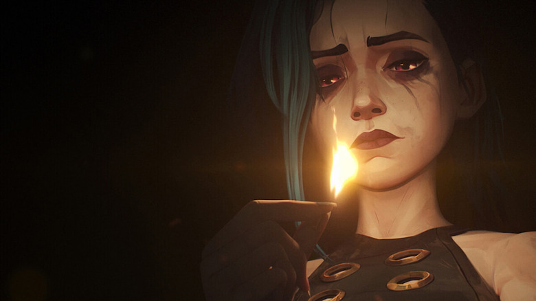 Powder (Ella Purnell) looks at a lit match in Arcane