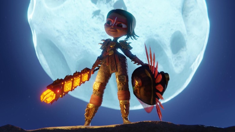 Maya (Zoe Saldaña) stands in front of a full moon in Maya and the Three