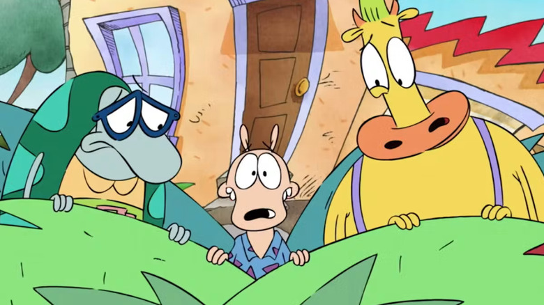 Filbert, Rocko, and Heffer hide behind a plant in Rocko's Modern Life.