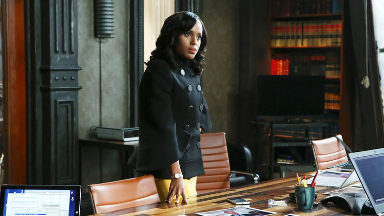 Kerry Washington as Olivia Pope, leaning over a desk in Scandal.