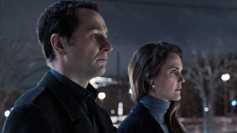 Matthew Rhys as Philip Jennings and Keri Russell as Elizabeth Jennings, standing together outside in The Americans.