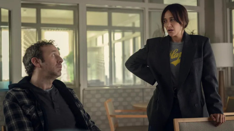 Mike Waters (Chris O'Dowd) sits as Amanda (Rashida Jones) looks at him in disgust on Black Mirror