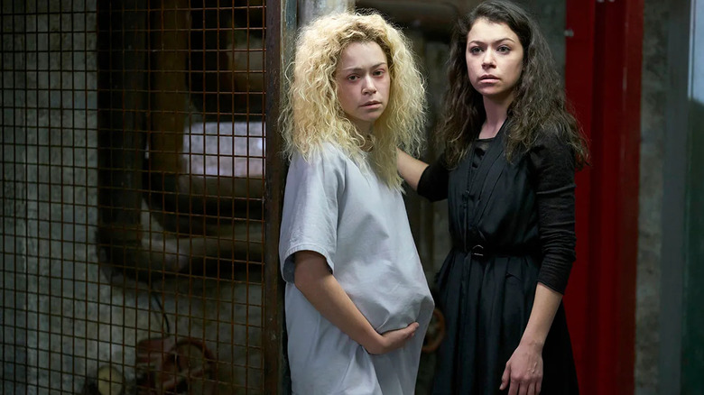 A pregnant Helena (Tatiana Maslany) stands next to Sarah Manning (Tatiana Maslany) on Orphan Black