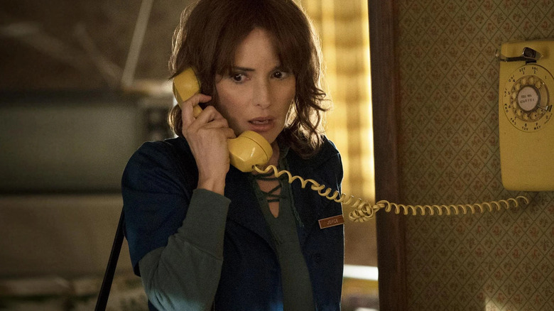 Joyce Byers (Winona Ryder) answers a phone in Stranger Things