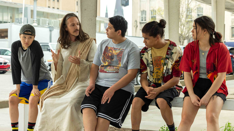 Four indigenous teens sit with White Jesus in Reservation Dogs.