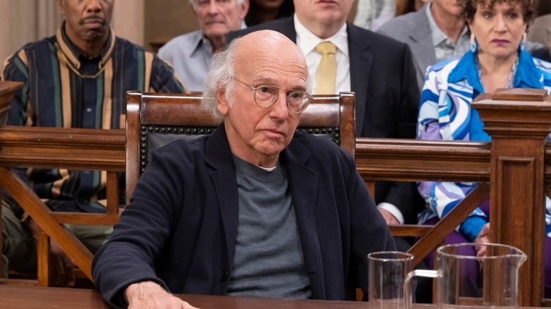 Larry David as a version of himself, sitting in court in Curb Your Enthusiasm.