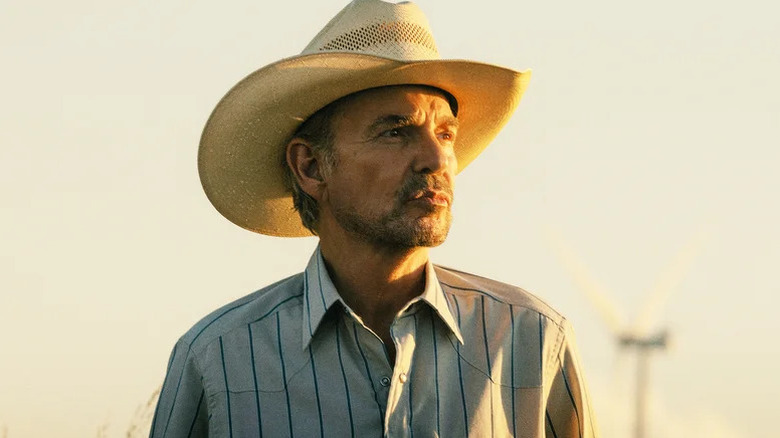 Billy Bob Thornton as Tommy standing outside in a cowboy hat in Landman
