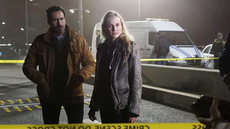 Demián Bichir as Marco standing next to Diane Kruger as Sonya at a crime scene in The Bridge