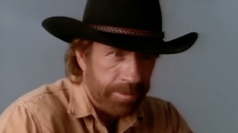 Chuck Norris as Cordell Walker wearing a black cowboy hat in Walker, Texas Ranger