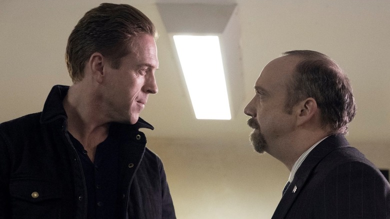 Bobby Axelrod (Damian Lewis) and Chuck Rhoades (Paul Giamatti) glare at each other in Billions