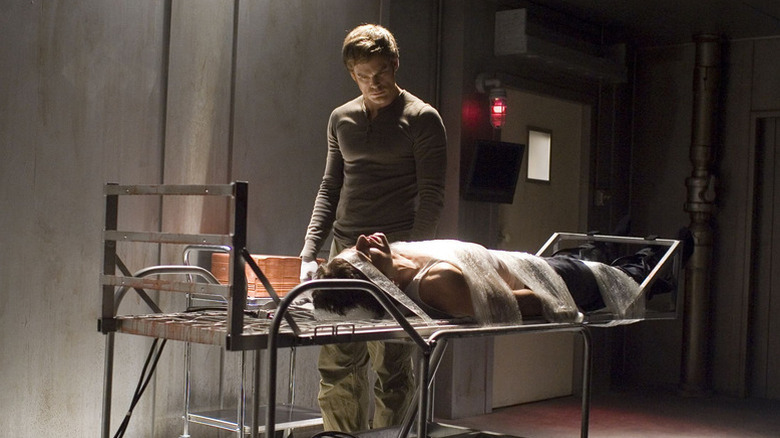 Dexter Morgan (Michael C. Hall) looks down at a victim strapped to a gurney in Dexter