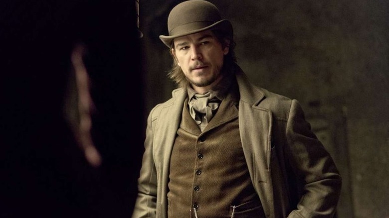 Ethan Chandler (Josh Hartnett) stands looking thoughtfully in Victorian clothing in Penny Dreadful