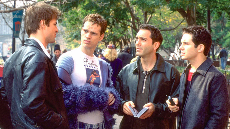 Brian Kinney (Gale Harold) speaks to Justin Taylor (Randy Harrison), Ben Bruckner (Richard Gant), and Michael Novotny (Hal Sparks) in Queer as Folk (2000)