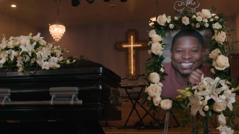 A picture of Brandon Johnson (Jason Mitchell) stands by his casket in The Chi