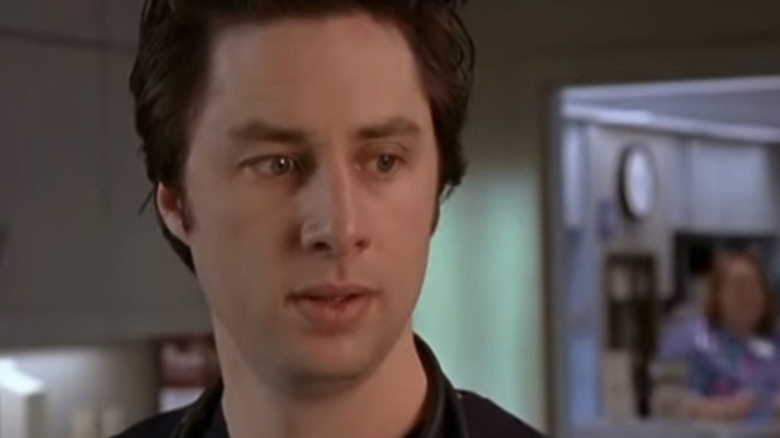 John C. McGinley as Perry Cox and Zach Braff as J.D., looking at each other in a hospital room on Scrubs.