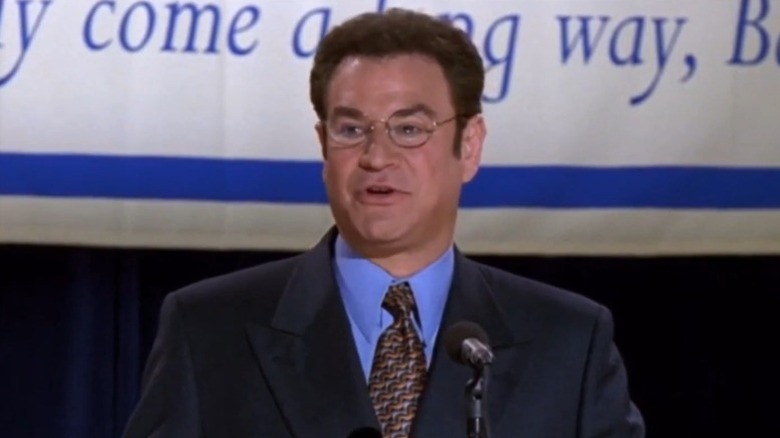 Arliss Michaels standing in front of a microphone on Arliss S4E1