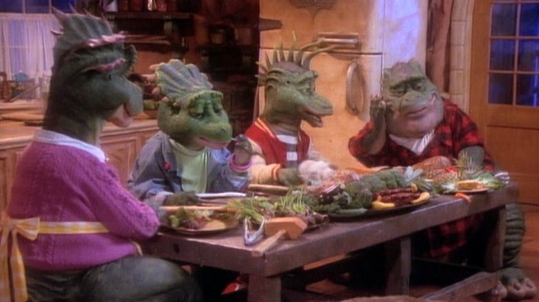 The Sinclair family sitting around the dinner table on Dinosaurs S2E2