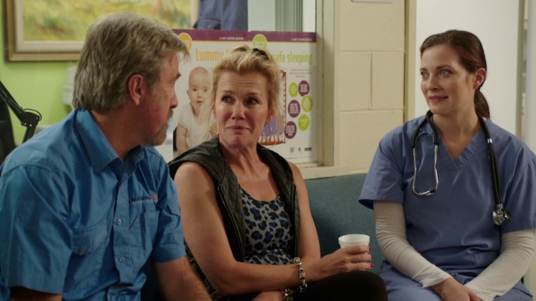Wayne, Julie, and Bess sitting in a hospital waiting room on Upper Middle Bogan S2E6