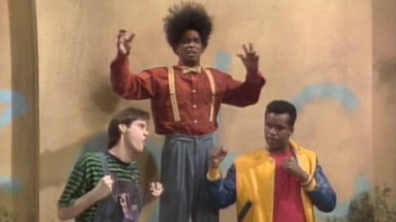 Jim Carrey, Damon Wayans, and David Alan Grier wearing colorful clothes in In Living Color