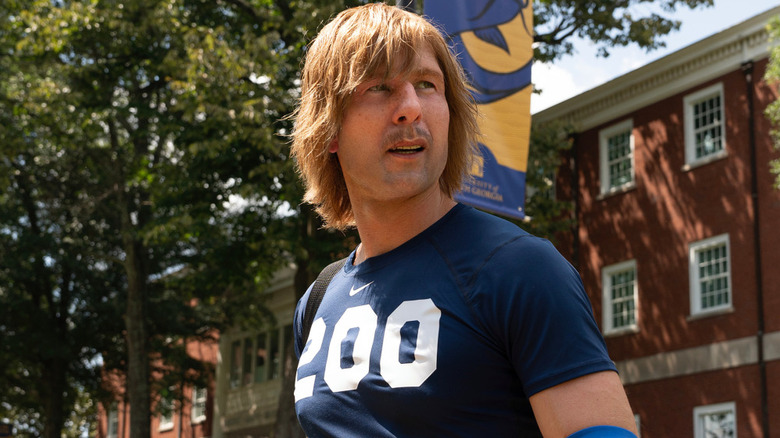 Russ Halliday (Glen Powell) stands on campus in his Chad Powers disguise on Chad Powers