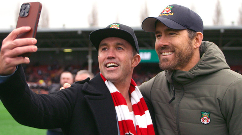 Rob Mac takes a selfie with Ryan Reynolds on the soccer field on Welcome to Wrexham