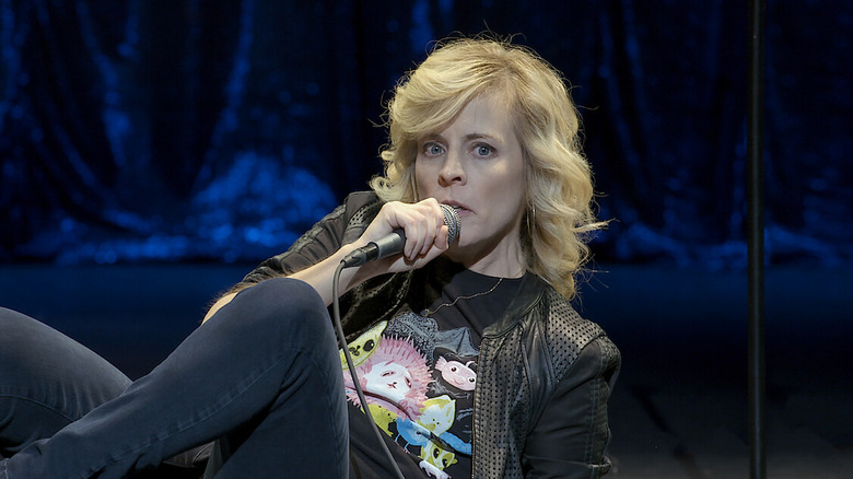 Maria Bamford reclines on stage in Maria Bamford: Old Baby (2017)