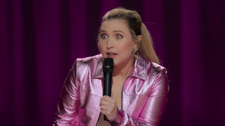 Taylor Tomlinson leans forward wide-eyed in Taylor Tomlinson: Have It All (2024)