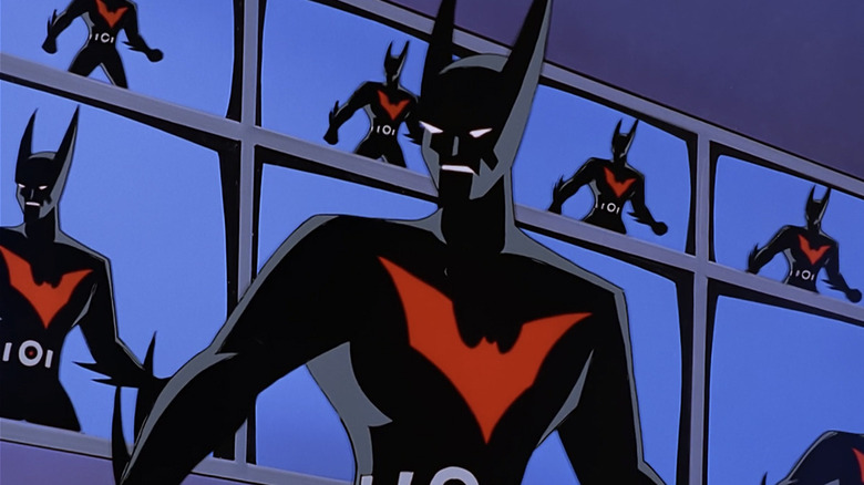 Batman stands in front of numerous monitors in Batman Beyond