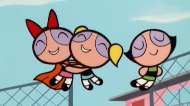 Blossom, Bubbles, and Buttercup flying together and smiling in The Powerpuff Girls
