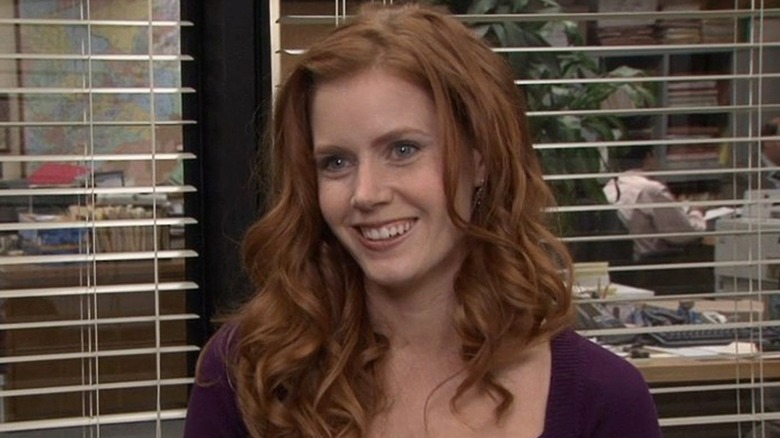 Amy Adams as Katy, smiling in an interview in "The Office."
