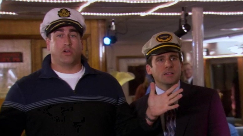 Rob Riggle as Captain Jack and Steve Carell as Michael Scott, standing together on the boat in "The Office."